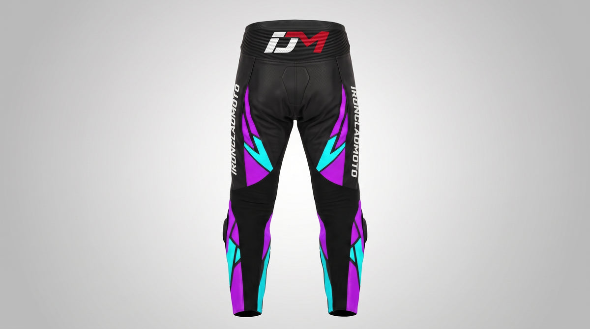 Black athletic pants with purple and teal geometric accents, featuring a red and white 'iDM' logo on the waistband and vertical branding on the legs, shown against a light gray gradient background.